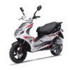 A white scooter with red accents parked on top of the road.