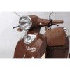 A close up of the headlight on a brown scooter