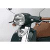 A close up of the headlight on a moped