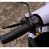 A close up of the handle bars on a purple scooter.