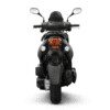 A black motorcycle with its lights on is shown.