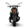 A motorcycle with its lights on and the rear view mirror turned down.