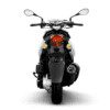 A motorcycle with its lights on and the rear view mirror turned down.