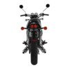 A motorcycle with the lights on and handlebars down.
