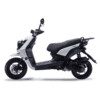 A white scooter is parked on the ground.