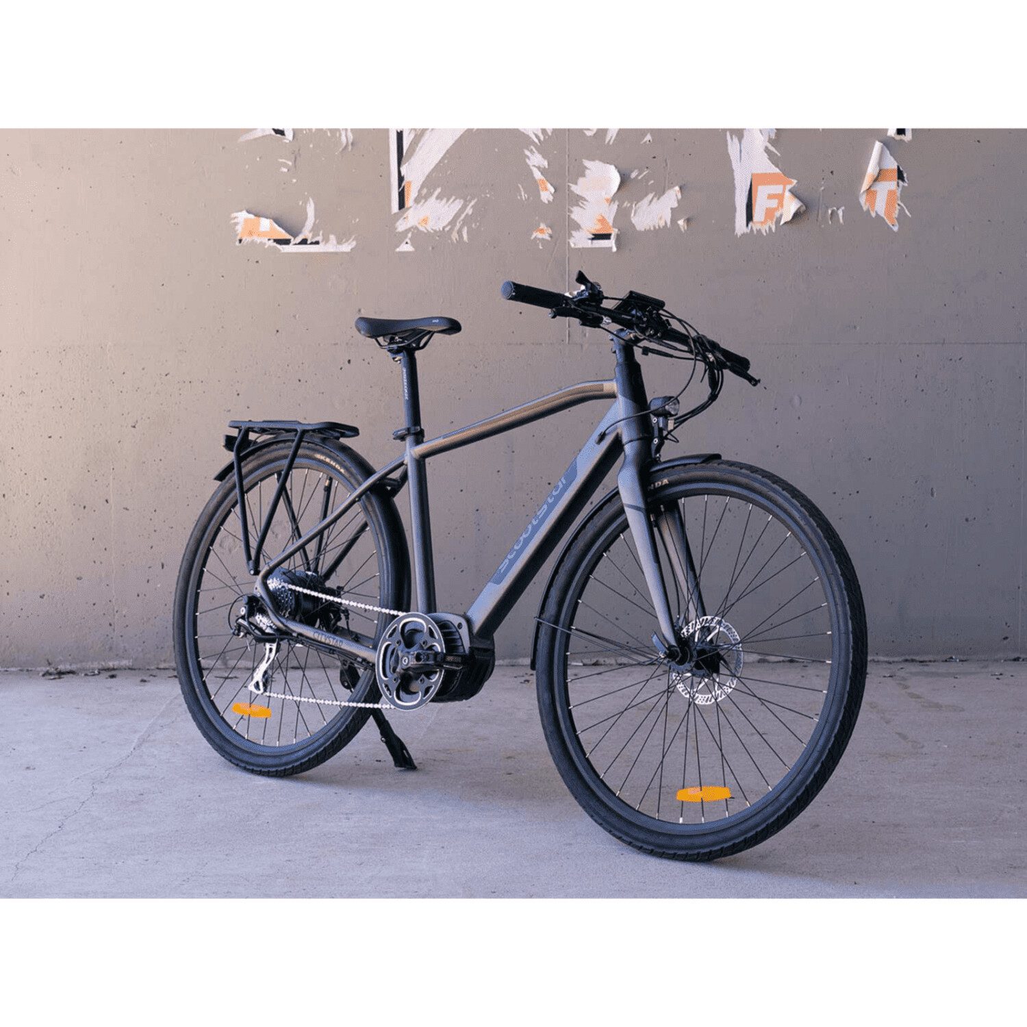 A bicycle is parked in front of a wall.