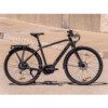 A black bicycle parked on the side of a road.