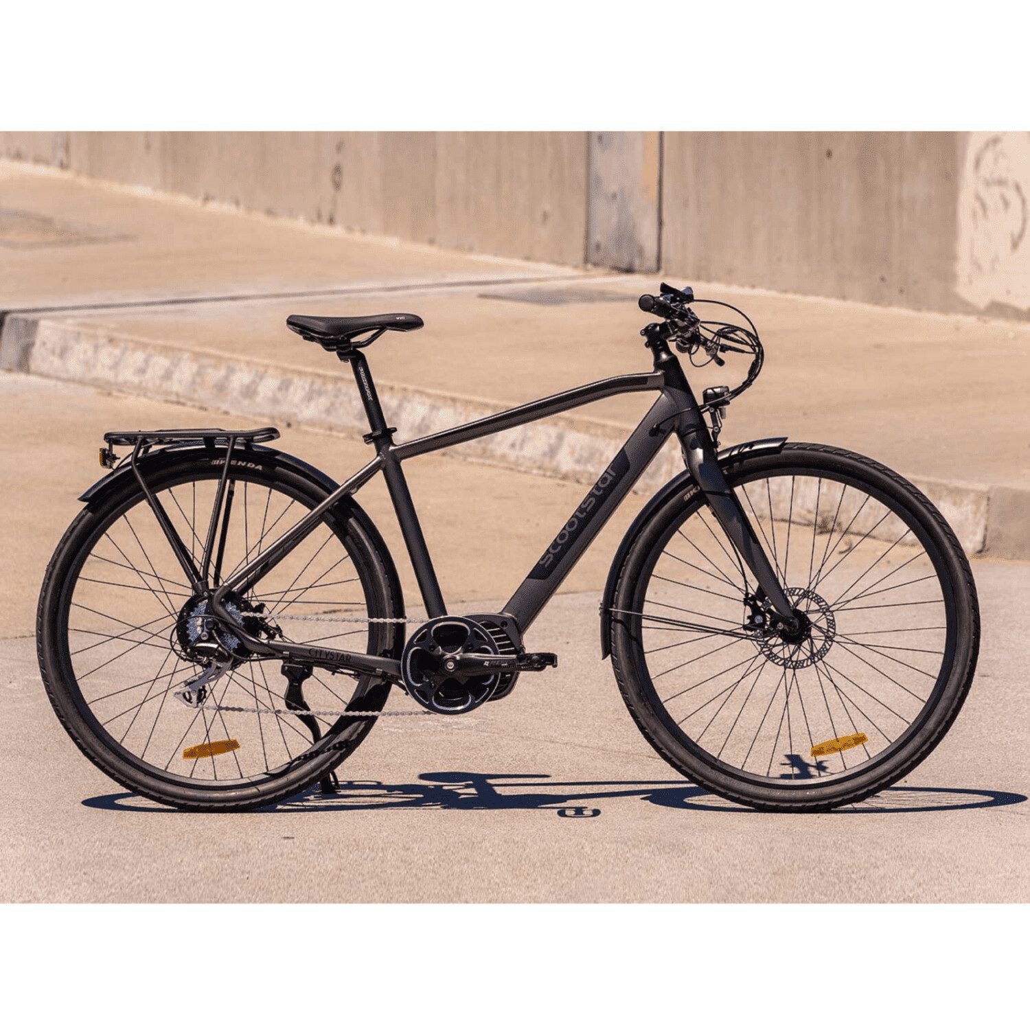 A black bicycle parked on the side of a road.