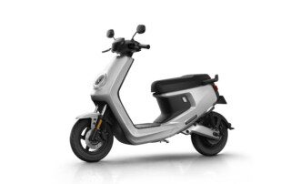 A white scooter is parked on the ground.