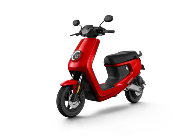 A red scooter is parked on the ground.