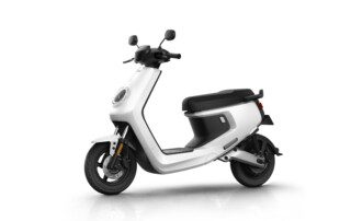 A white scooter is parked on the ground.