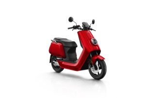A red scooter is parked on the ground.