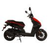 A red and black scooter is parked on the ground.