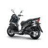 A black scooter parked on top of the ground.