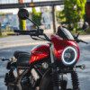 A red motorcycle parked on the side of a road.