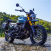 A motorcycle parked on top of a wet road.